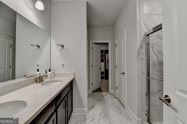 full bath featuring baseboards, a shower stall, a sink, and marble finish floor