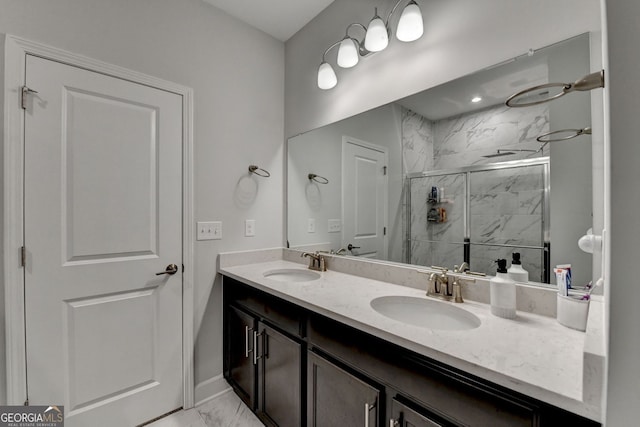 bathroom with double vanity, a sink, a marble finish shower, and marble finish floor