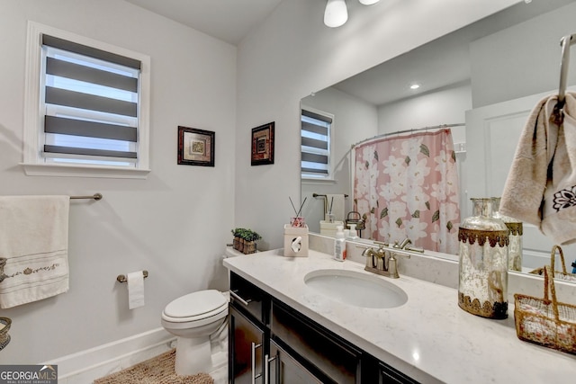full bathroom with baseboards, vanity, toilet, and curtained shower