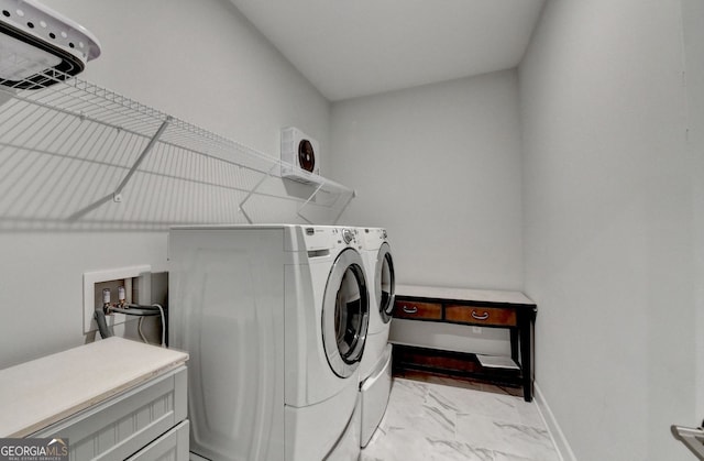 laundry room featuring laundry area, marble finish floor, baseboards, and separate washer and dryer