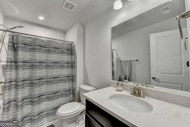 bathroom featuring vanity, curtained shower, toilet, and visible vents