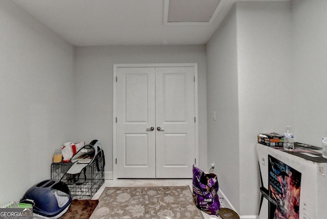 interior space featuring light tile patterned floors and baseboards