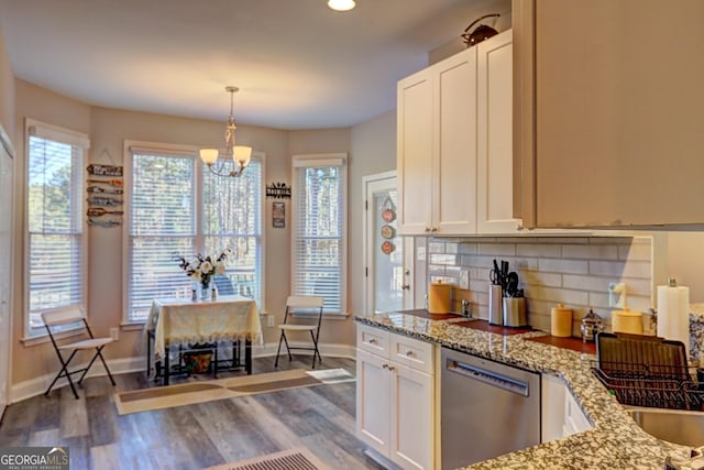 kitchen with white cabinets, dishwasher, dark wood-style flooring, light stone countertops, and backsplash