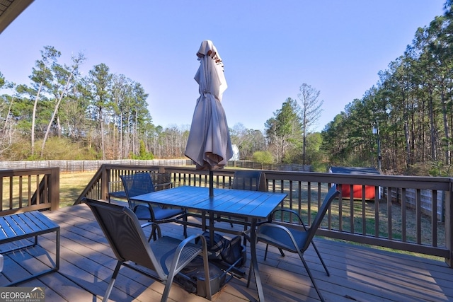 deck featuring fence and outdoor dining area