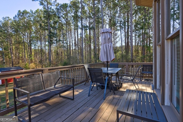 wooden terrace featuring outdoor dining area