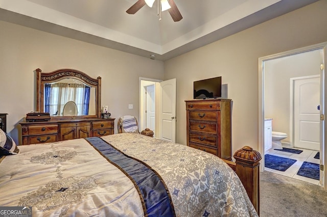 carpeted bedroom with a ceiling fan and ensuite bath