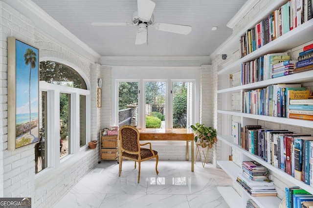 sunroom / solarium featuring ceiling fan