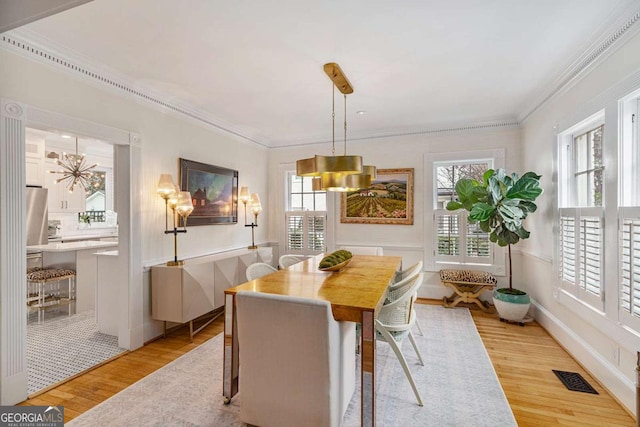 dining room featuring plenty of natural light, visible vents, and light wood-type flooring