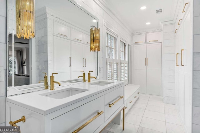 bathroom featuring a sink, visible vents, recessed lighting, and crown molding