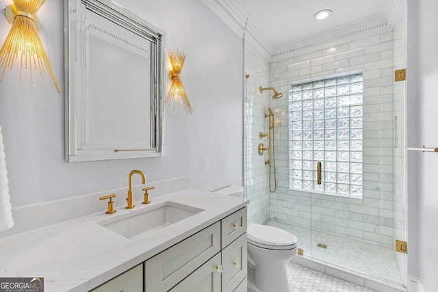 bathroom with vanity, a shower stall, toilet, and ornamental molding