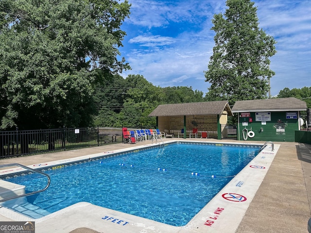 pool featuring a patio area and fence