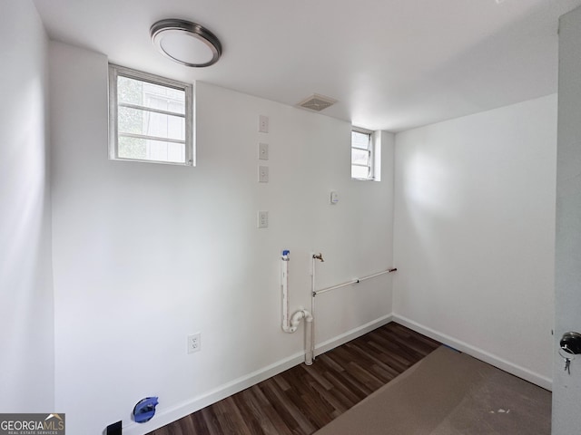 laundry room featuring laundry area, wood finished floors, visible vents, and baseboards