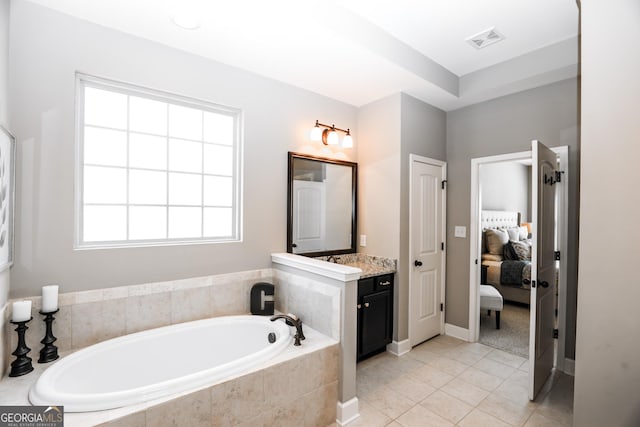 ensuite bathroom featuring visible vents, ensuite bathroom, vanity, a bath, and tile patterned floors