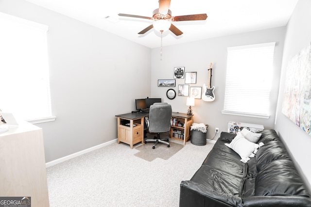 carpeted home office featuring visible vents, baseboards, and a ceiling fan