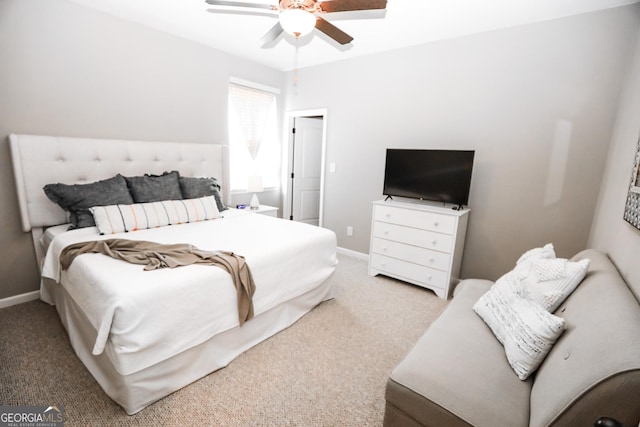 carpeted bedroom featuring a ceiling fan and baseboards