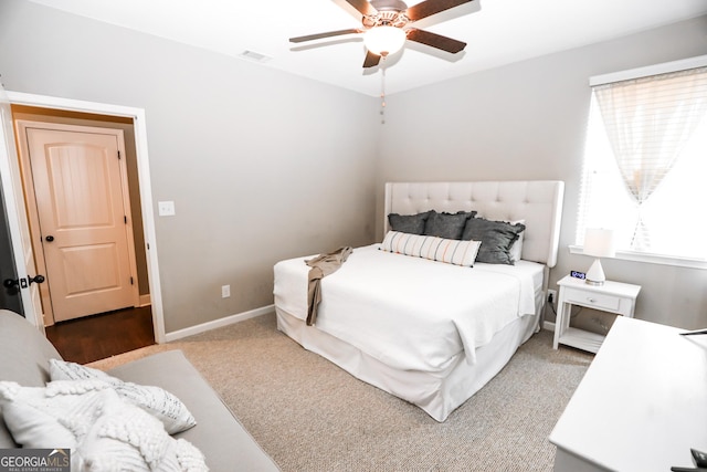 bedroom featuring a ceiling fan, visible vents, and baseboards