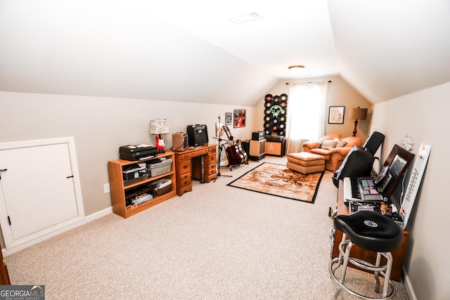 carpeted home office featuring vaulted ceiling and baseboards