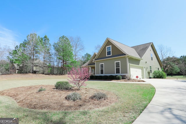 view of front of home with a garage, driveway, and a front yard