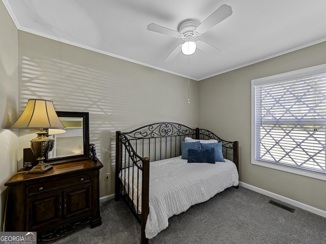 carpeted bedroom with ceiling fan, ornamental molding, visible vents, and baseboards