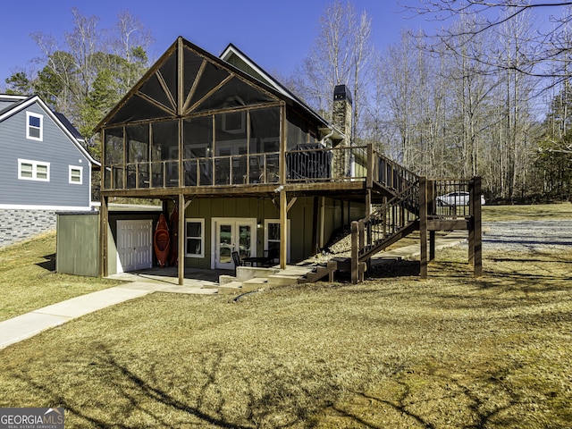 view of front of property with a sunroom, a chimney, stairway, a deck, and french doors