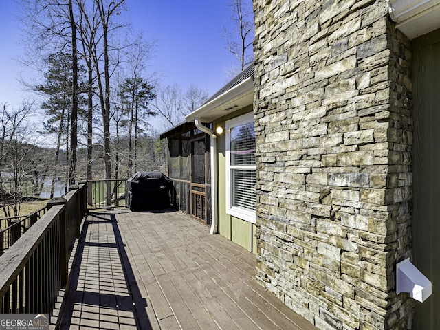 wooden terrace featuring grilling area