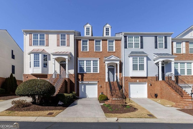 multi unit property featuring a garage, concrete driveway, and brick siding