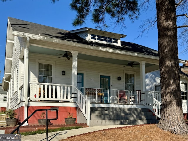 view of front of home with a porch, stairway, and ceiling fan