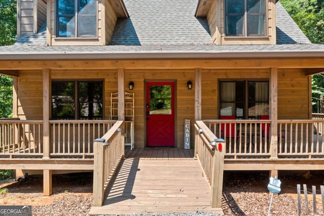 entrance to property with a shingled roof