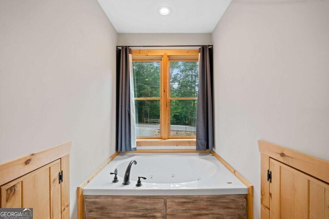 bathroom featuring a tub with jets