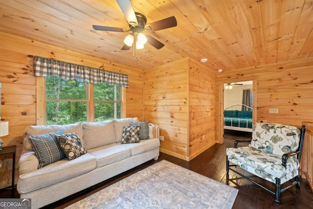 living room featuring a ceiling fan, wood walls, wood ceiling, and hardwood / wood-style flooring