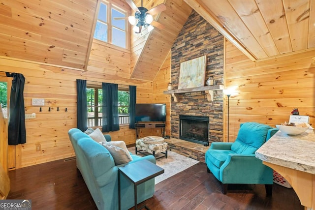 living room featuring dark wood-type flooring, a ceiling fan, wood ceiling, wood walls, and a stone fireplace