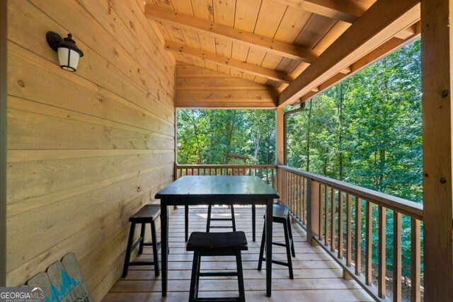 wooden terrace featuring outdoor dining area