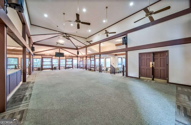 empty room featuring recessed lighting, a towering ceiling, and baseboards