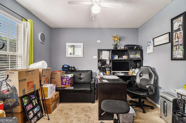 office with a textured ceiling, ceiling fan, carpet, and baseboards