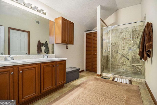 full bath featuring lofted ceiling, a stall shower, double vanity, and a sink