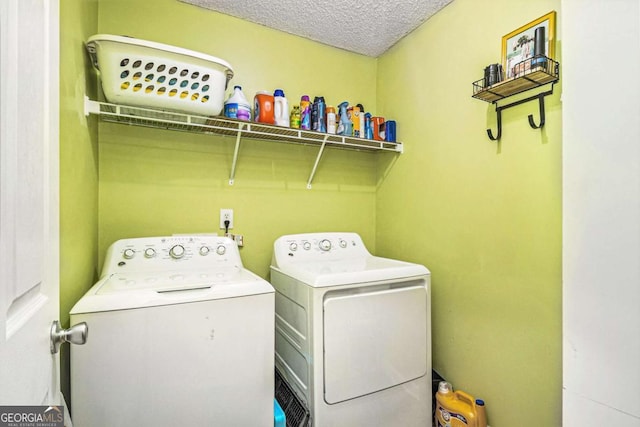 laundry area featuring laundry area, separate washer and dryer, and a textured ceiling