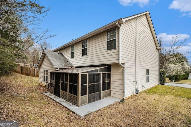 back of property with a sunroom