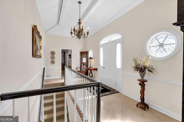 foyer with baseboards, visible vents, lofted ceiling with beams, an inviting chandelier, and light tile patterned flooring