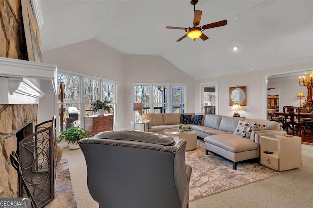 living area featuring high vaulted ceiling, a fireplace with raised hearth, carpet flooring, and ceiling fan with notable chandelier