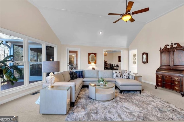 carpeted living area with high vaulted ceiling, visible vents, baseboards, and a ceiling fan