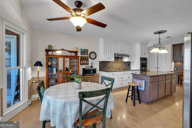 dining area with ceiling fan and light tile patterned floors