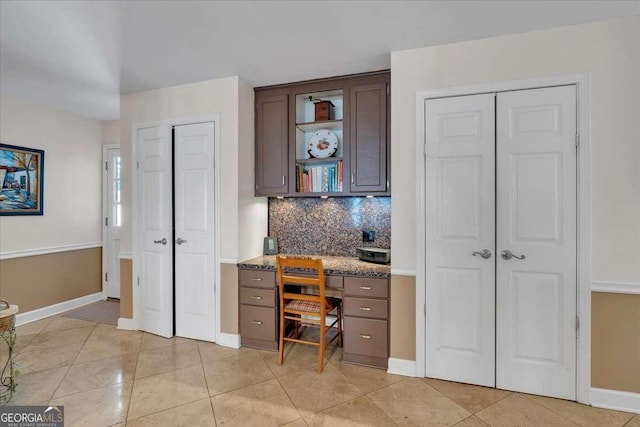 office with light tile patterned floors and baseboards