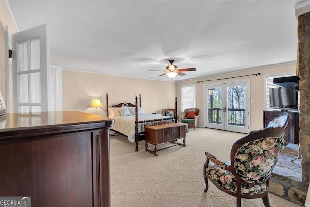 bedroom featuring access to outside, french doors, light colored carpet, and crown molding