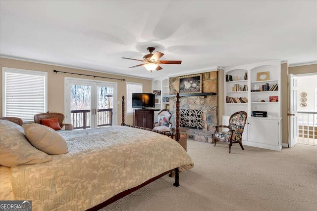 bedroom with a fireplace, carpet flooring, access to exterior, ornamental molding, and french doors