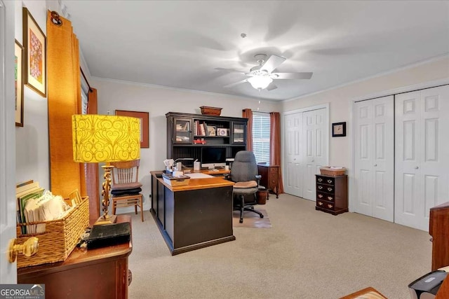 office area with a ceiling fan, light colored carpet, and crown molding