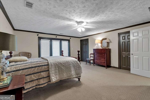 bedroom with light carpet, ornamental molding, a textured ceiling, and visible vents