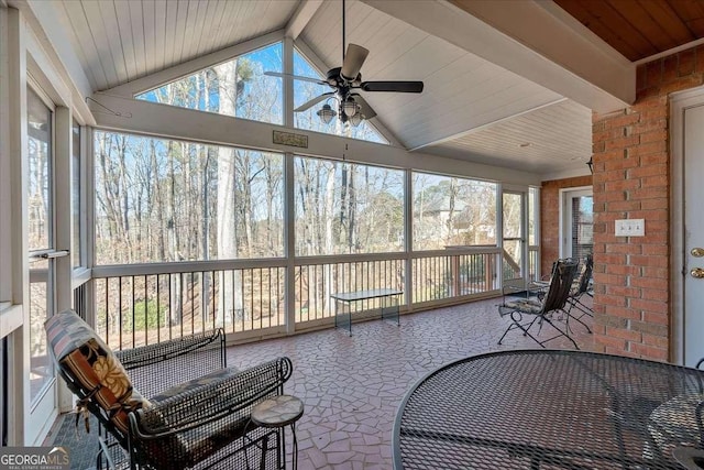 sunroom with vaulted ceiling with beams, wooden ceiling, and ceiling fan