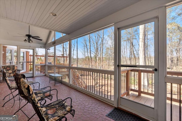 sunroom / solarium featuring ceiling fan, wood ceiling, and vaulted ceiling