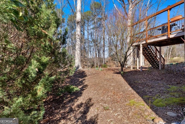 view of yard featuring stairs and a wooden deck