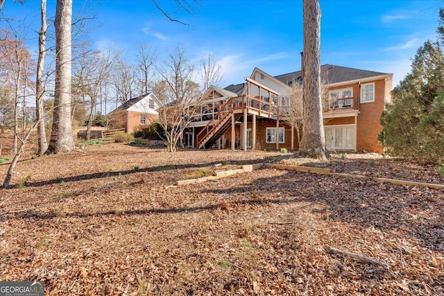 back of property with stairs and a deck